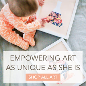 Baby with science artwork and text "Empowering art as unique as she is"