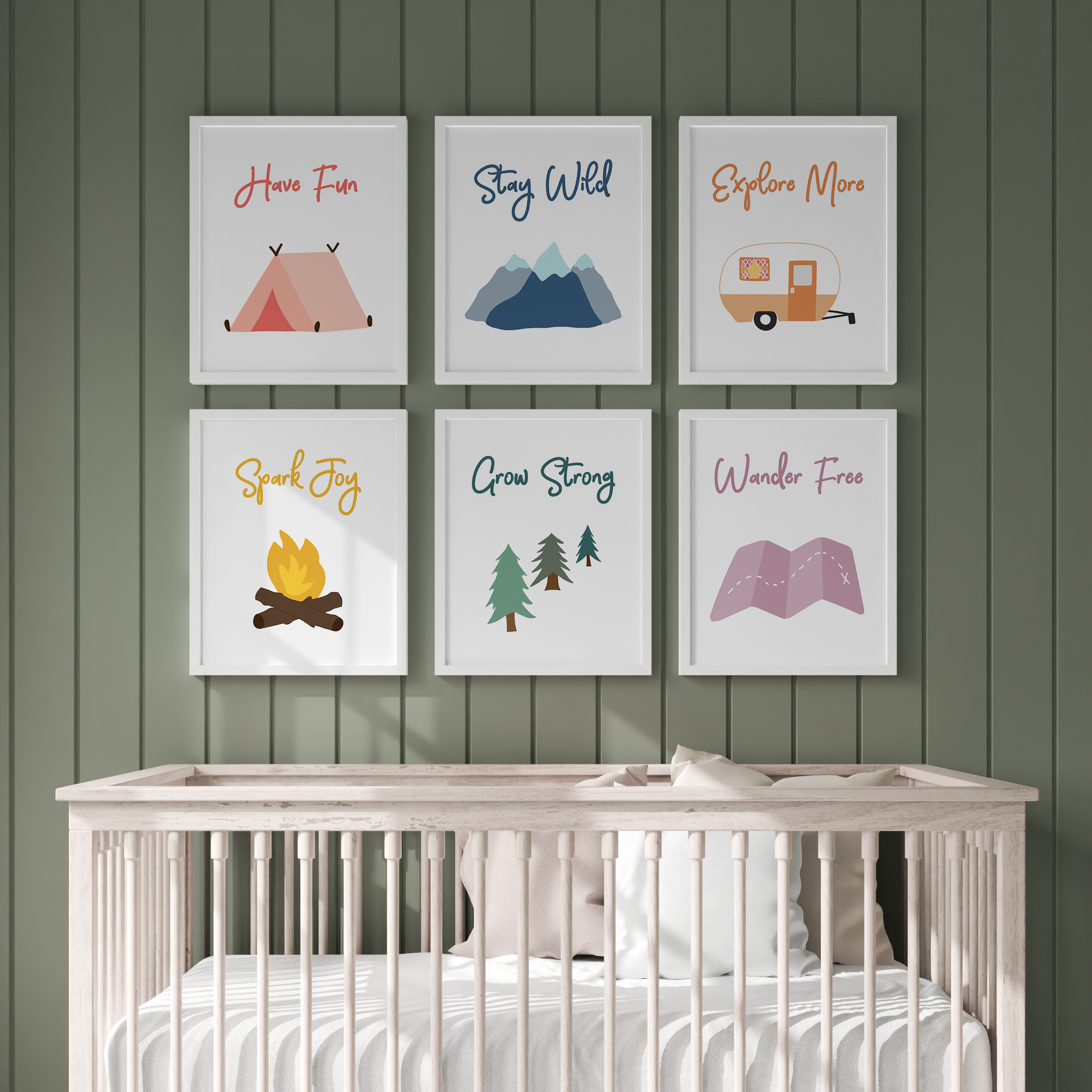 Camping theme wall art on green wall over baby crib
