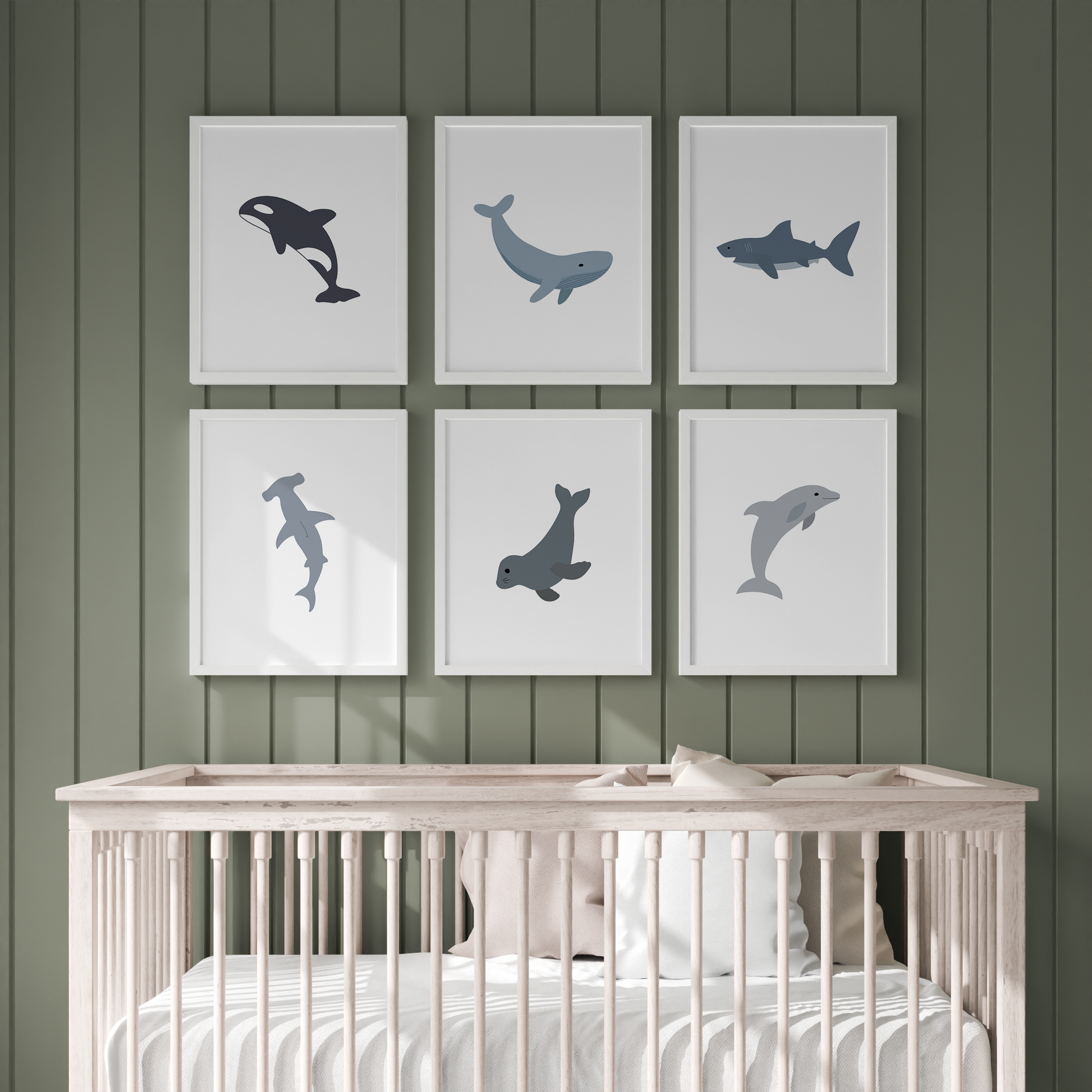 Ocean nursery wall art above crib on green wall